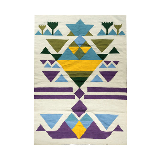 "A woven rug with geometric patterns in green, yellow, blue, and purple on a light beige background, displayed vertically."