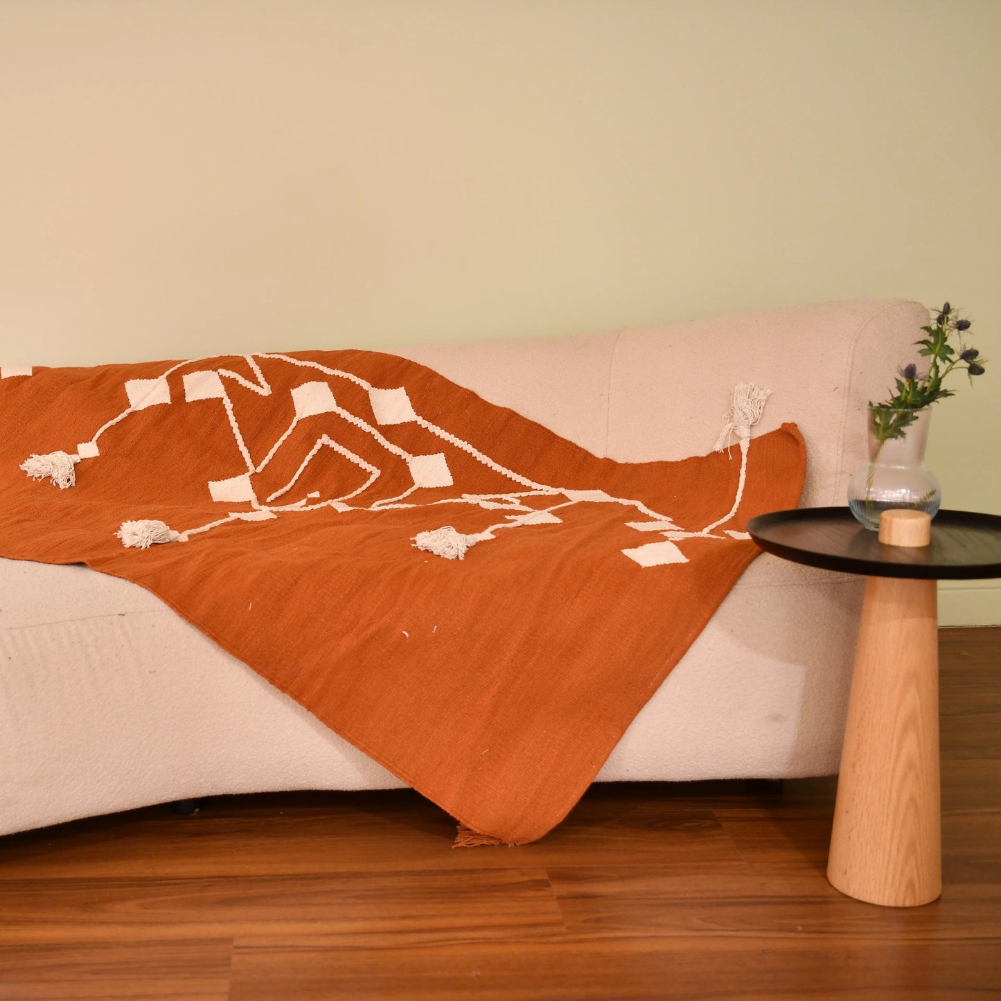 This 1 x 1.5 meter rug features a bold, Coral background and a striking white geometric pattern that consists of interconnected diamond shapes, creating a visually engaging composition. The edges are adorned with fringed tassels made of the same material, contributing to the traditional and artisanal aesthetic.