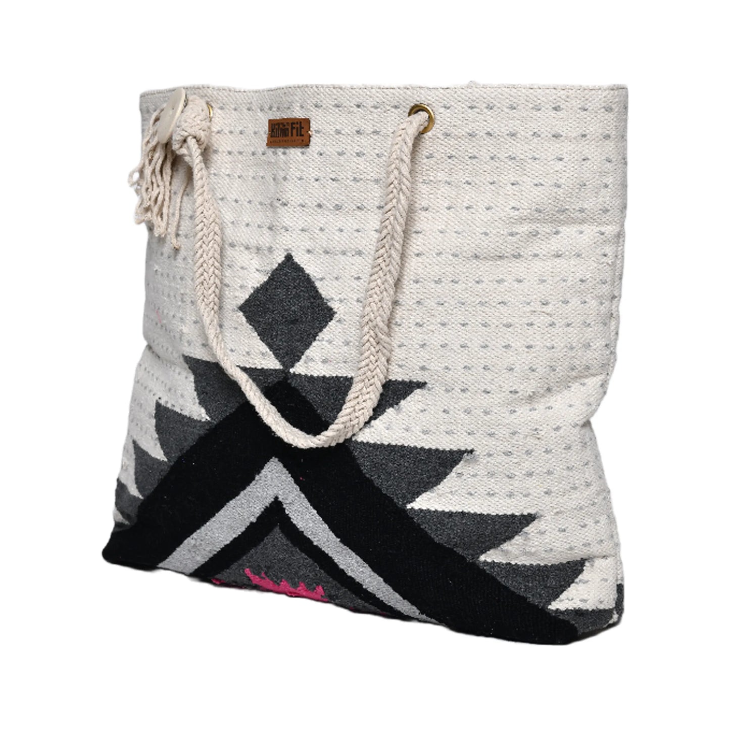 "A woven tote bag with a geometric pattern in black, white, and gray, featuring a rope handle and a small tassel."